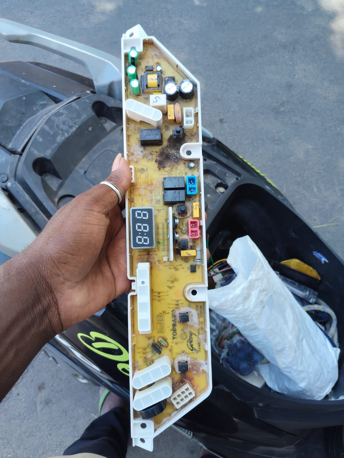 Technician working on the front panel of a washing machine